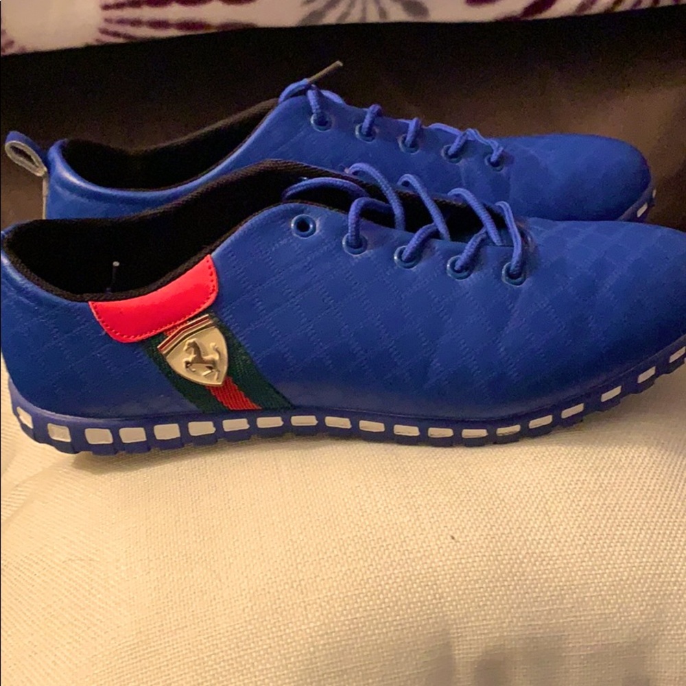 Blue sneakers. Ferrari-esque symbol on the side.